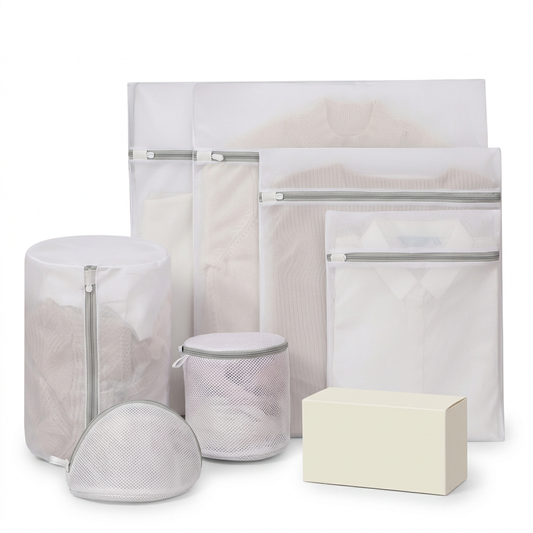 White mesh laundry bag assortment with gray zippers on a white background with an unbranded ivory carton.